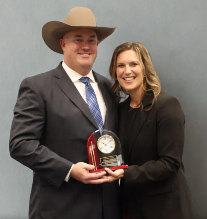 Dr. Jason Mogonye, MD, holding an award