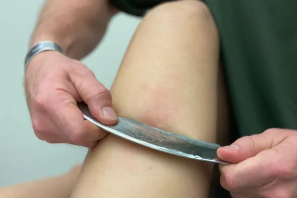 Hands-on manual therapy on an athlete's leg